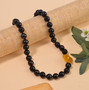 yellow jade golden freshwater pearl and shungite beaded necklace in rhodium over sterling silver shown in a lifestyle photo