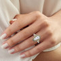 moissanite and yellow sapphire shield cut halo ring in rhodium over sterling silver worn on a hand