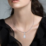moissanite shield cut halo pendant necklace in rhodium over sterling silver worn around the neck