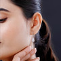 moissanite and pink sapphire shield cut halo lever back earrings in rhodium over sterling silver worn on the ear