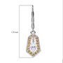 moissanite and yellow sapphire shield cut halo lever back earrings in rhodium over sterling silver shown for size comparison