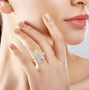 pink yellow and white diamond bypass ring in 14k white gold worn on a hand