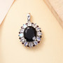 black jade rainbow moonstone and garnet pendant necklace in rhodium over sterling silver shown in a lifestyle photo