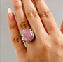 pink jade and white zircon floral ring in rhodium over sterling silver worn on a hand