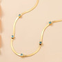 blue apatite herringbone necklace in 18k yellow gold over sterling silver shown in a lifestyle photo