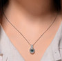 blue and white moissanite interchangeable halo pendant necklace in rhodium over sterling silver worn around the neck