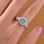 blue and white moissanite interchangeable halo ring in rhodium over sterling silver worn on a hand
