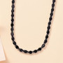 black jade tennis necklace in rhodium over sterling silver shown in a lifestyle photo