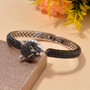 black spinel and chrome diopside panther cuff bracelet in black and white rhodium over sterling silver shown in a lifestyle photo