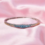 blue apatite bangle bracelet in 18k yellow gold and rhodium over sterling silver shown in a lifestyle photo