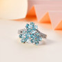 blue apatite and white zircon flower cluster ring in rhodium over sterling silver shown in a lifestyle photo