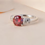 red and white moissanite solitaire ring in rhodium over sterling silver shown in a lifestyle photo