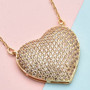 champagne cubic zirconia pave heart cluster necklace in 18k yellow gold over sterling silver shown in a lifestyle photo