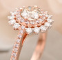 white and pink diamond halo ring in 14k rose and 14k white gold shown in a lifestyle photo