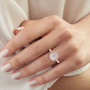 white and pink diamond halo ring in 14k rose and 14k white gold worn on a hand