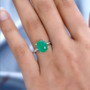 green jade oval two-tone solitaire ring in 18k yellow gold and rhodium over sterling silver worn on a hand