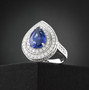 ceylon sapphire and diamond triple halo ring in 950 platinum shown in a lifestyle photo
