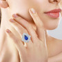ceylon sapphire and diamond triple halo ring in 950 platinum worn on a hand
