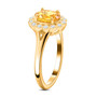 side view of orange sapphire and diamond halo ring in 18k yellow gold