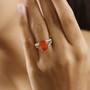 fire opal padparadscha champagne and white diamond 10k yellow gold ring worn on a hand