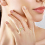 yellow and white diamond halo ring in 950 platinum worn on a hand