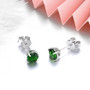 close up of natural chrome diopside 5mm round stud earrings in rhodium over 925 sterling silver