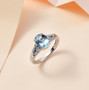 aquamarine blue and white diamond ring in 14k white gold shown in a lifestyle photo