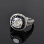close up of moissanite and blue sapphire double halo rhodium over sterling silver ring