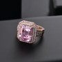 kunzite pink sapphire and zircon double halo 18k rose gold over sterling silver ring shown in a lifestyle photo