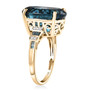 side view of oval london blue topaz blue and white diamond 10k yellow gold ring