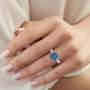 lab grown blue and white diamond rhodium over sterling silver ring worn on a hand