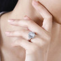 rhodium over sterling silver moissanite halo ring worn on a hand