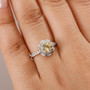 yellow apatite and white zircon 18k yellow gold over sterling silver halo ring worn on a hand
