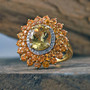 yellow apatite orange sapphire and zircon 18k yellow gold over sterling silver halo ring shown in a lifestyle photo