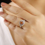 orange sapphire red and white diamond double halo infinity shank ring in solid 14k white gold worn on a hand
