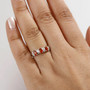 fire opal and white zircon trilogy ring in rhodium over sterling silver worn on a hand