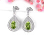 peridot and white zircon rhodium over sterling silver dangle earrings shown in a lifestyle photo