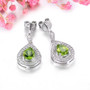 side view of peridot and white zircon rhodium over sterling silver dangle earrings