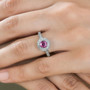 pink sapphire and diamond round double halo ring in 10k white gold worn on a hand