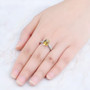 citrine and white zircon rhodium over sterling silver solitaire ring worn on a hand
