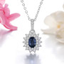 blue sapphire and white zircon rhodium over sterling silver double halo pendant necklace shown in a lifestyle photo