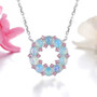 ethiopian opal and pink tourmaline rhodium over sterling silver circle necklace shown in a lifestyle photo