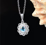 mercury mist topaz and white zircon halo pendant necklace in rhodium over sterling silver shown in a lifestyle photo