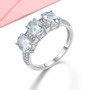 aquamarine and white zircon rhodium over sterling silver trilogy ring shown in a lifestyle photo
