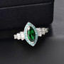 tsavorite garnet paraiba tourmaline and diamond marquise halo ring in 950 platinum shown in a lifestyle photo