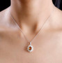 hessonite garnet chrome diopside and moissanite halo pendant necklace in rhodium over sterling silver worn around the neck