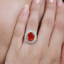 fire opal yellow and white diamond halo ring in 14k yellow gold worn on a hand