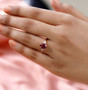 pink apatite and diamond ring in 10k rose gold worn on a hand