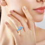 diamond and blue apatite double halo 950 platinum ring worn on a hand