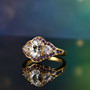 lab created white and purple sapphire trilogy halo ring in 18k yellow gold over sterling silver shown in a lifestyle photo